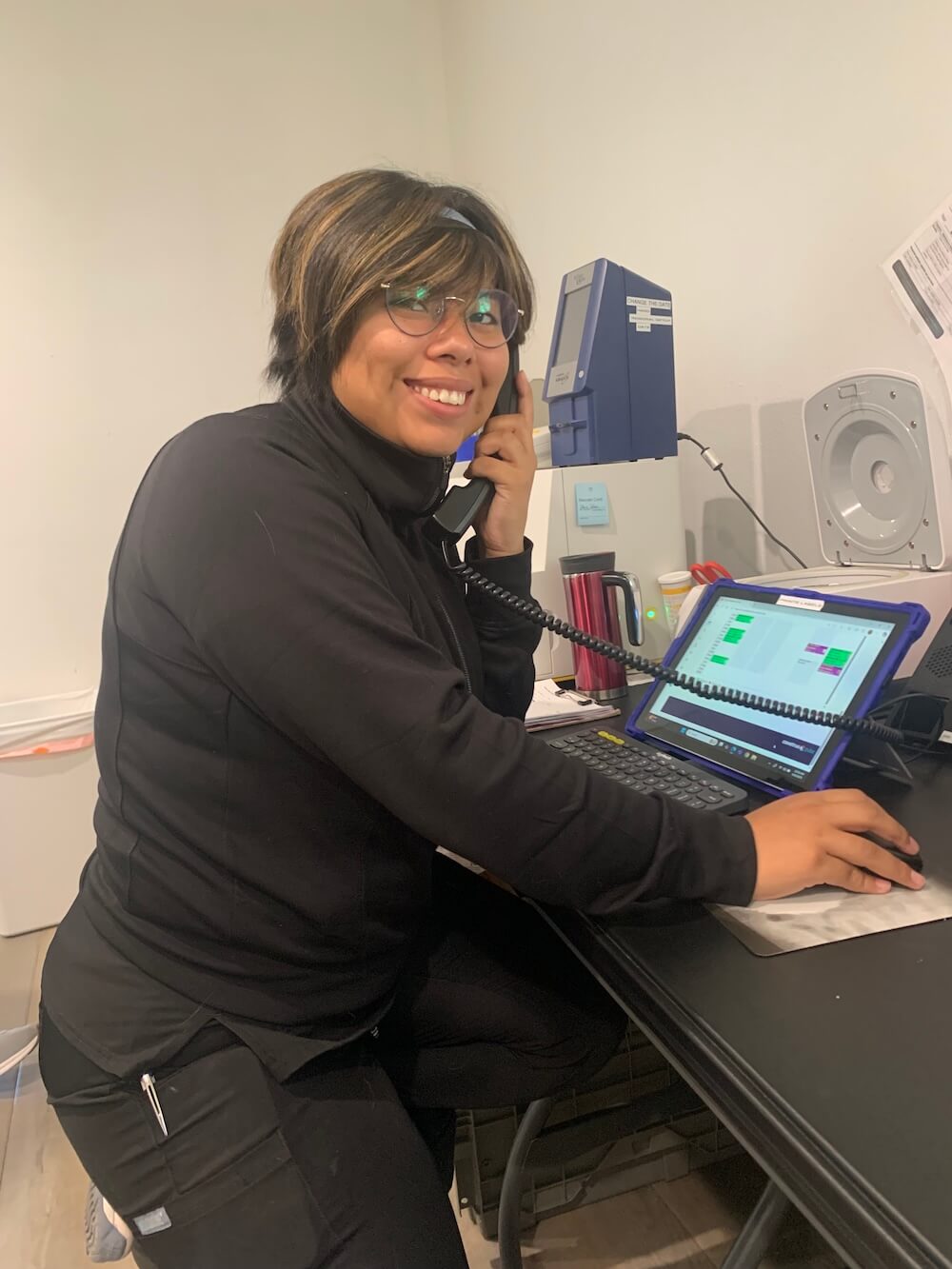 Friendly veterinary team member answering the phone and scheduling appointments in Santa Fe